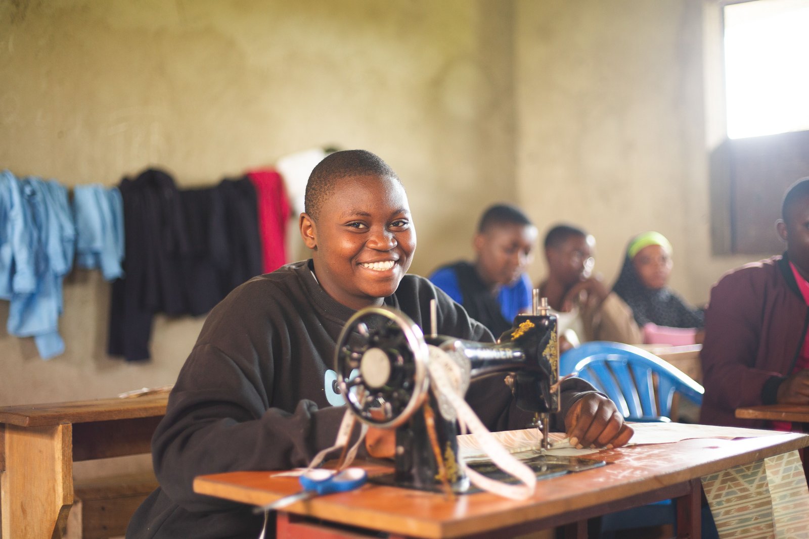 Young person learning tailoring at a vocational class